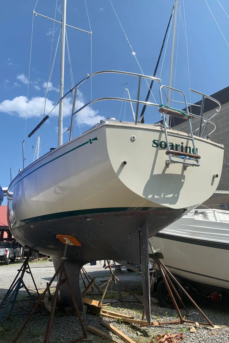 Slide: The Image of 1979 Sabre 28-2 sailboat on stands, named "Soaring," under clear blue sky. - 5