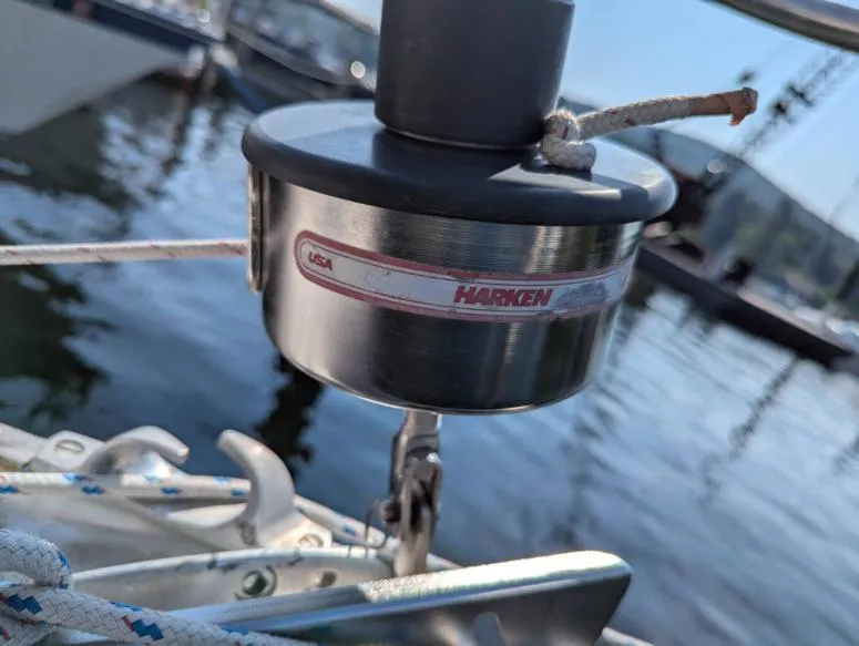 Slide: The Image of Harken sailboat hardware on a 1979 Sabre 28-2, docked by the water. - 6
