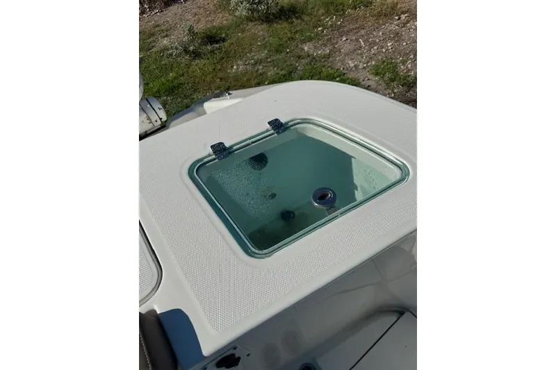 Slide: The Image of 2023 Edgewater 370CC boat deck with a closed hatch, outdoor setting. - 11