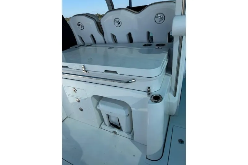 Slide: The Image of 2023 Edgewater 370CC boat interior with seating and storage compartments. - 13