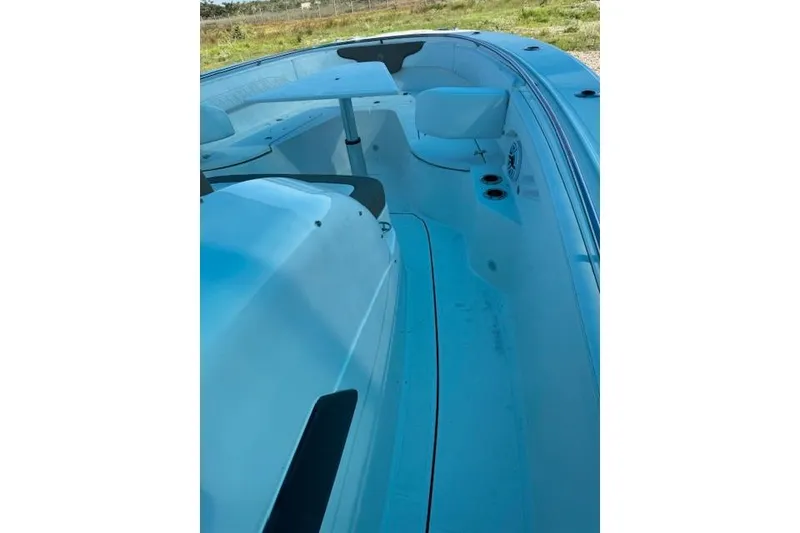 Slide: The Image of 2023 Edgewater 370CC boat interior with seating and cup holders. - 15