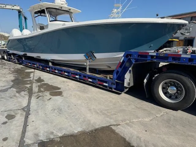 Slide: The Image of 2023 Edgewater 370 boat on trailer at marina, ready for transport. - 6