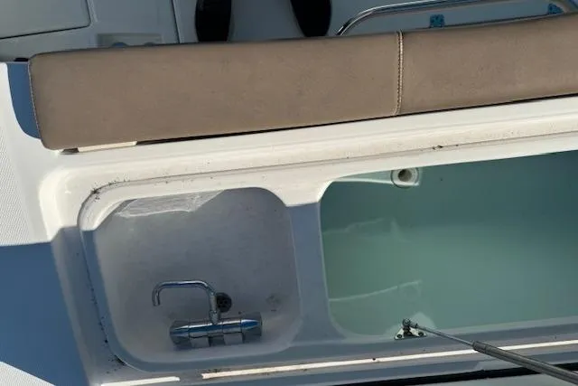 Slide: The Image of 2023 Edgewater 370CC boat interior with sink and storage compartment. - 8