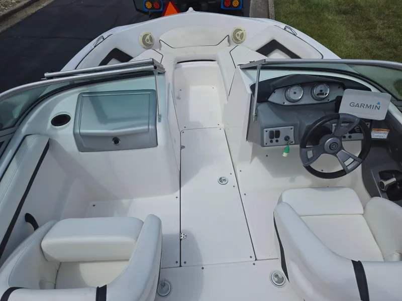 Slide: The Image of 2015 Yamaha Boats SX190 interior with steering wheel and seating, featuring Garmin equipment. - 11