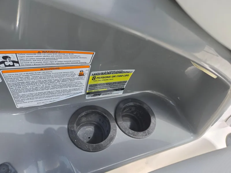 Slide: The Image of 2015 Yamaha SX190 boat warning labels and cup holders, maximum capacity 8 persons or 1160 lbs. - 14