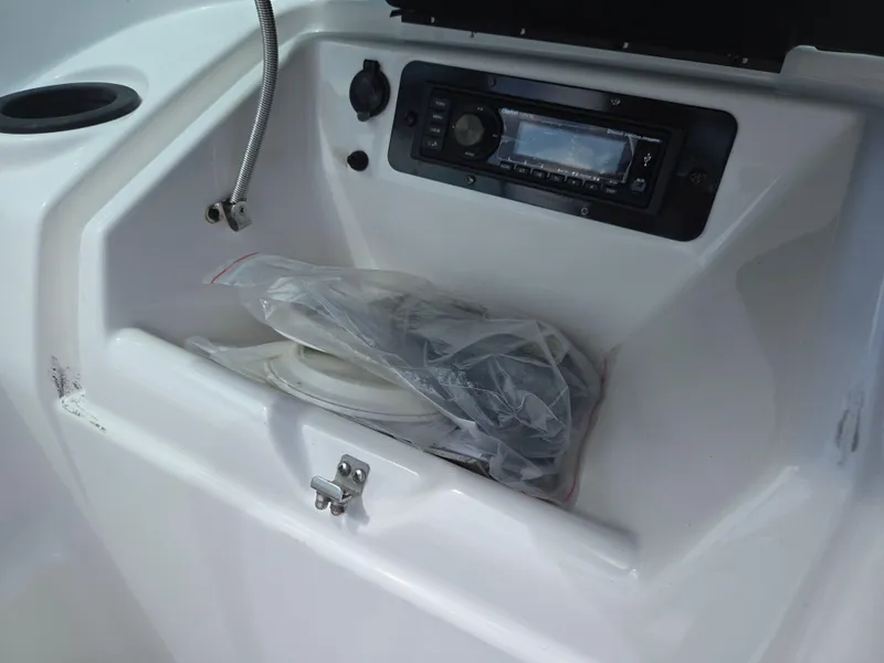 Slide: The Image of 2015 Yamaha SX190 boat dashboard with stereo system and storage compartment. - 15