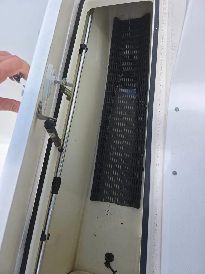 Slide: The Image of 2015 Yamaha SX190 boat storage compartment with open hatch and visible latch mechanism. - 17