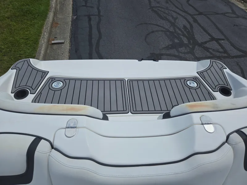 Slide: The Image of 2015 Yamaha SX190 boat deck with gray non-slip surface and cup holders. - 24