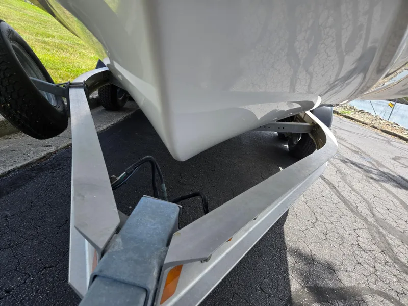 Slide: The Image of 2015 Yamaha Boats SX190 on trailer, close-up view of hull and wheels. - 7