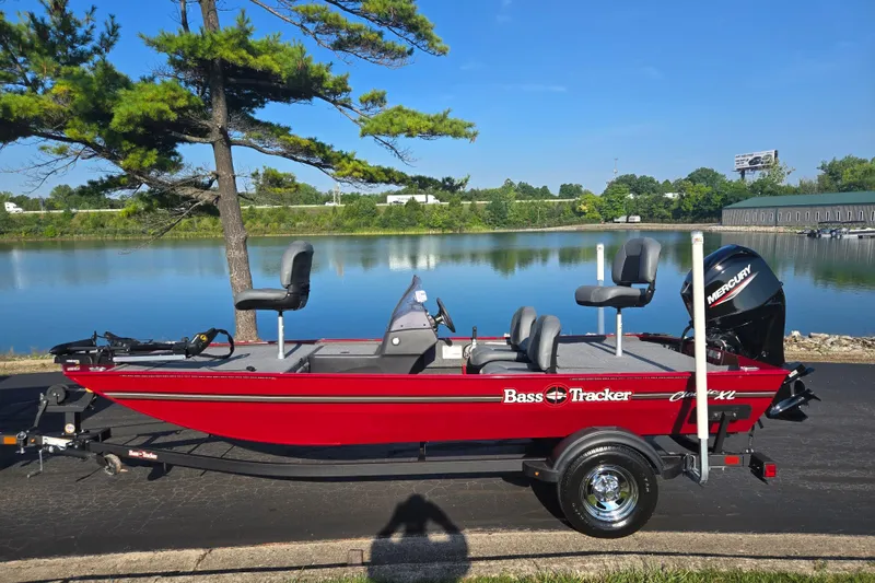 Slide: The Image of 2023 Tracker Bass Tracker Classic XL boat by a serene lake. - 10