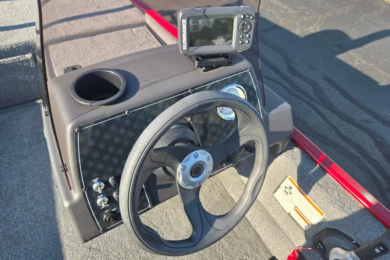 Slide: The Image of 2023 Tracker Bass Tracker Classic XL dashboard with steering wheel and fish finder. - 13