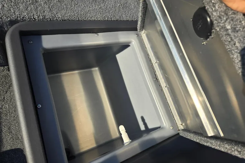 Slide: The Image of 2023 Tracker Bass Tracker Classic XL storage compartment, open lid, gray interior. - 15