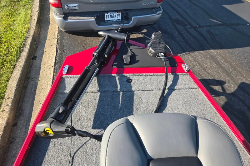 Slide: The Image of 2023 Tracker Bass Tracker Classic XL boat with trolling motor, parked near a vehicle. - 17