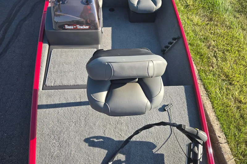 Slide: The Image of 2023 Tracker Bass Tracker Classic XL boat interior with gray seating and red trim. - 19