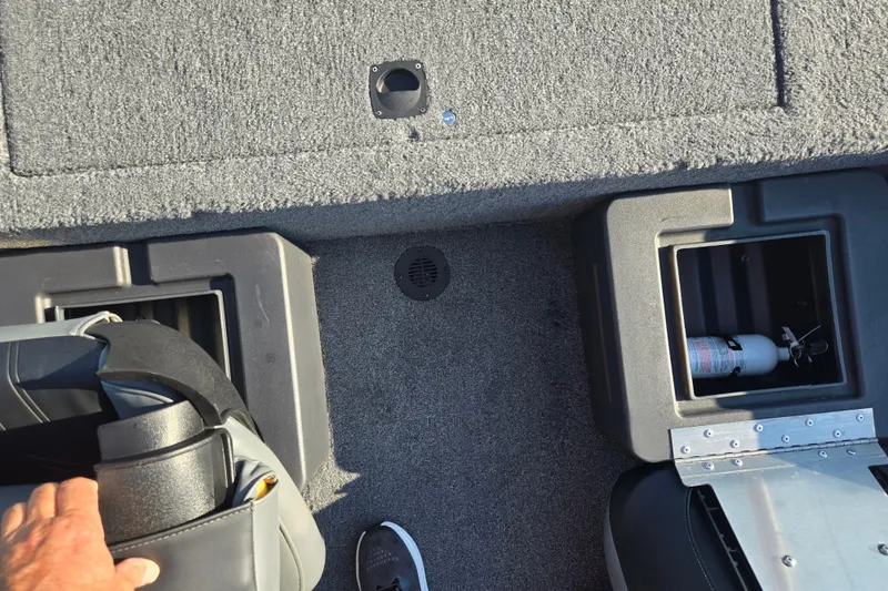 Slide: The Image of 2023 Tracker Bass Tracker Classic XL boat interior with storage compartments and fire extinguisher. - 21