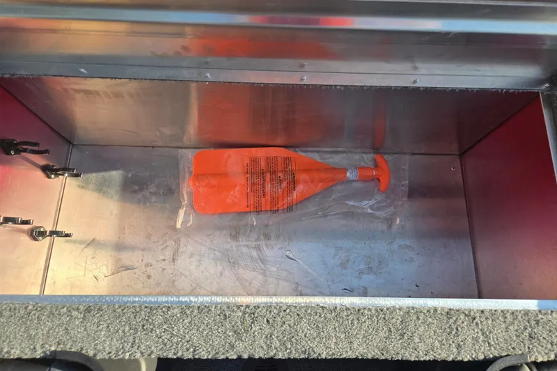 Slide: The Image of Storage compartment in 2023 Tracker Bass Tracker Classic XL with orange safety equipment. - 22