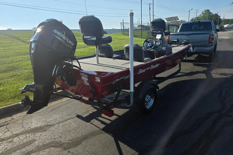 Slide: The Image of 2023 Tracker Bass Tracker Classic XL boat hitched to a truck on a sunny day. - 3