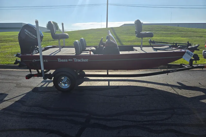 Slide: The Image of 2023 Tracker Bass Tracker Classic XL boat on trailer, parked on asphalt, sunny day. - 4