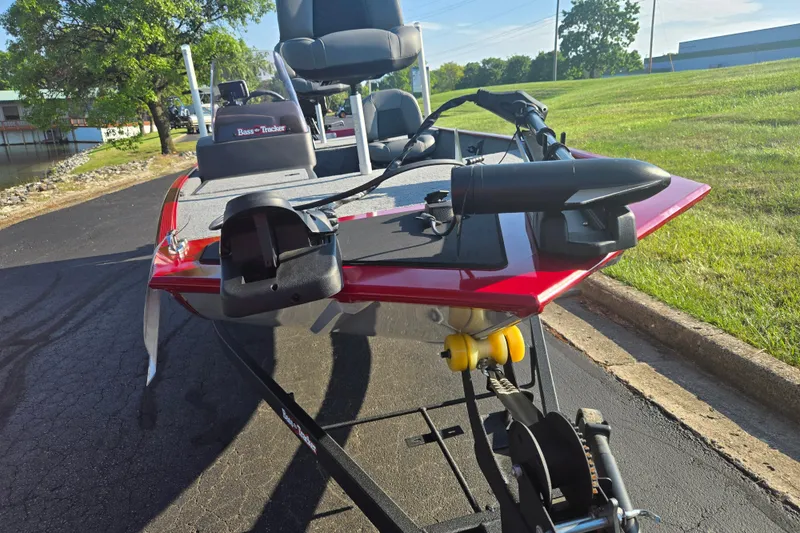 Slide: The Image of 2023 Tracker Bass Tracker Classic XL boat on trailer, parked on asphalt near grassy area. - 6