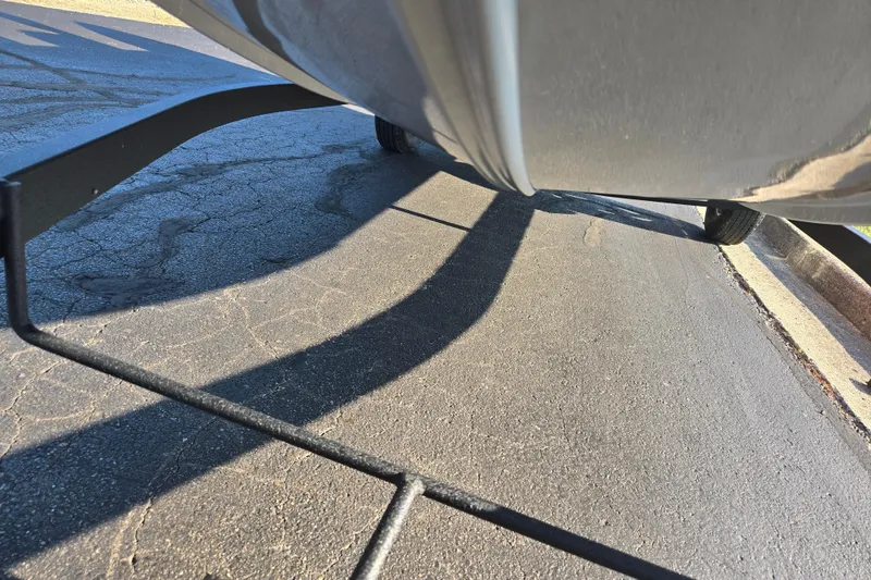 Slide: The Image of 2023 Tracker Bass Tracker Classic XL on trailer, close-up view of hull and pavement. - 7