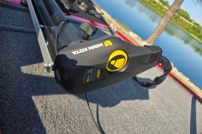 Slide: The Image of Minn Kota trolling motor on 2023 Tracker Bass Tracker Classic XL boat by a lake. - 8