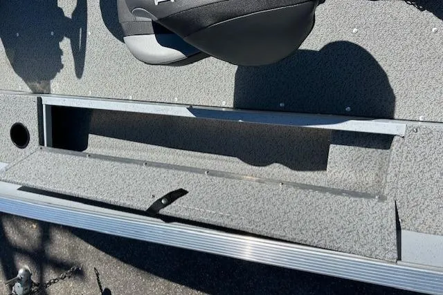 Slide: The Image of 2026 Lund 1600 Fury SS boat interior with storage compartment and seat. - 11