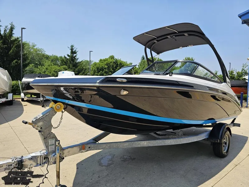 Slide: The Image of 2022 Yamaha Boats 195S on trailer, sleek black design, outdoor setting. - 13