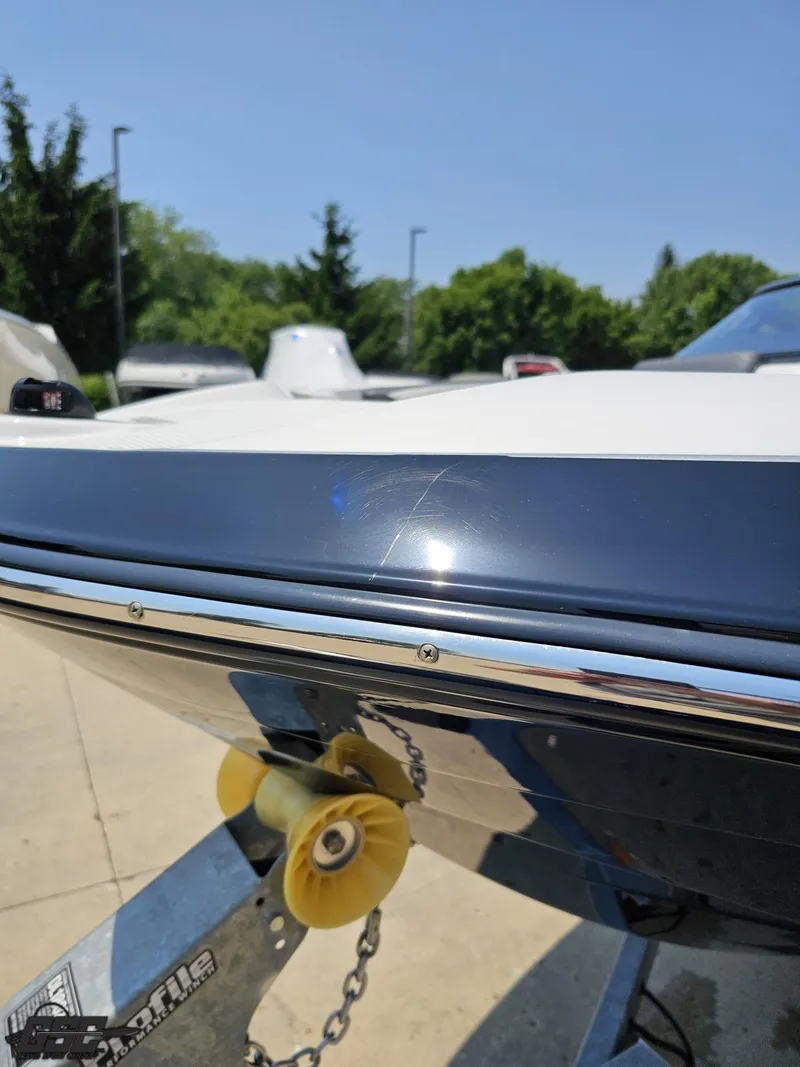 Slide: The Image of 2022 Yamaha Boats 195S on trailer, close-up of hull and bow roller. - 14