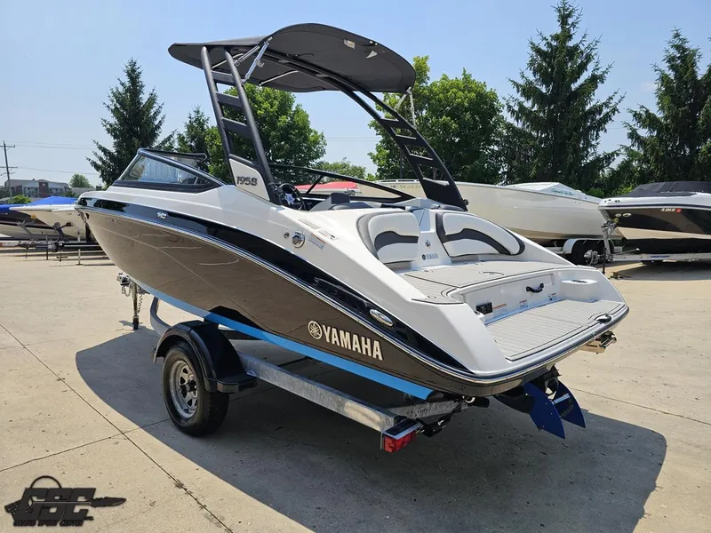 Slide: The Image of 2022 Yamaha Boats 195S on trailer, sleek design, black and white finish, outdoor display. - 23