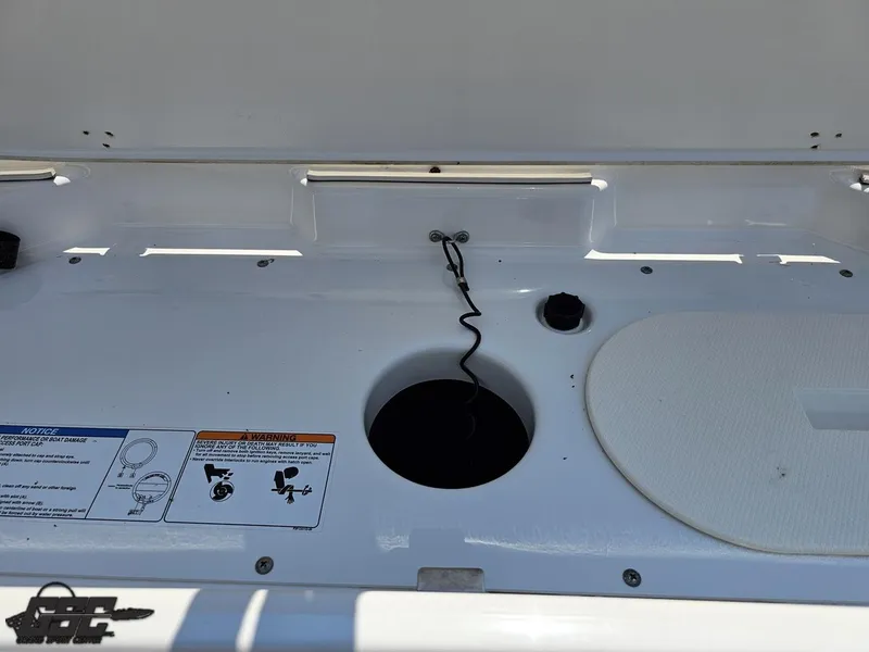 Slide: The Image of 2022 Yamaha Boats 195S storage compartment with safety instructions and wiring details. - 32