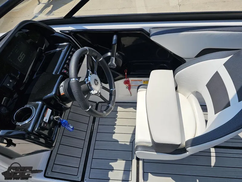 Slide: The Image of 2022 Yamaha Boats 195S cockpit with steering wheel and captain's chair, featuring sleek design. - 47