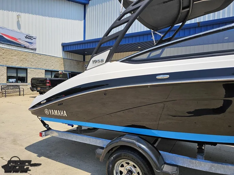 Slide: The Image of 2022 Yamaha Boats 195S on trailer, displayed outside a dealership. - 6