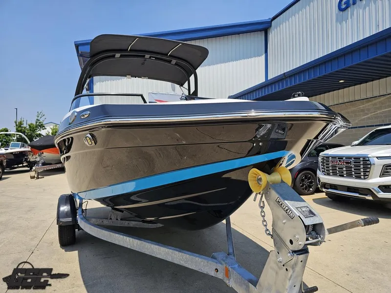 Slide: The Image of 2022 Yamaha Boats 195S on trailer, parked outdoors near a dealership. - 9