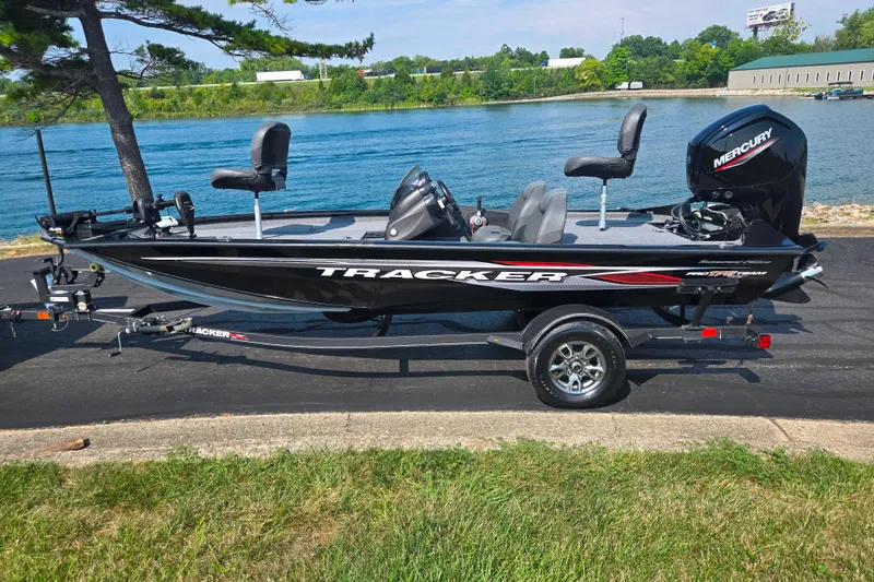 Slide: The Image of 2023 Tracker Pro Team 175 TXW fishing boat by a lake. - 10