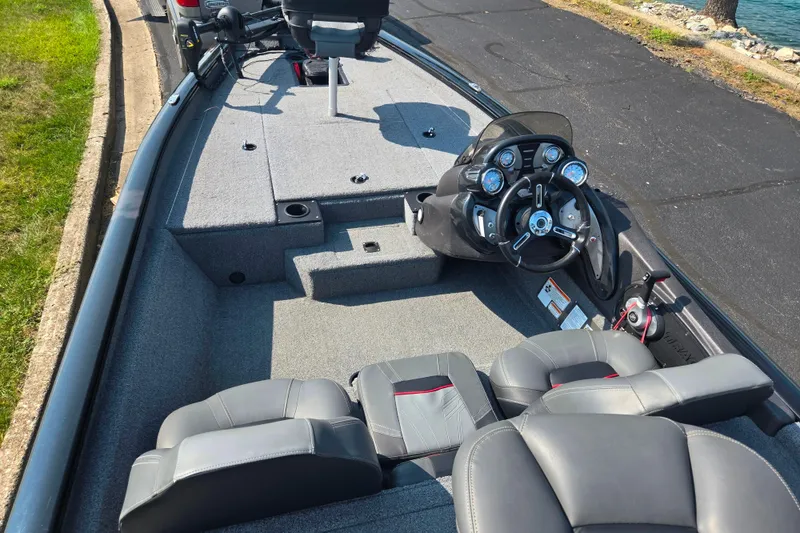 Slide: The Image of 2023 Tracker Pro Team 175 TXW boat interior with steering console and seating. - 11