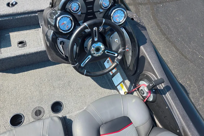 Slide: The Image of 2023 Tracker Pro Team 175 TXW boat cockpit with steering wheel and gauges. - 12