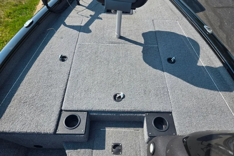 Slide: The Image of 2023 Tracker Pro Team 175 TXW boat deck with carpeted surface and seating area. - 14
