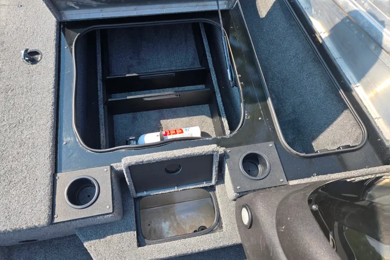 Slide: The Image of 2023 Tracker Pro Team 175 TXW boat storage compartments with cup holders and fire extinguisher. - 16