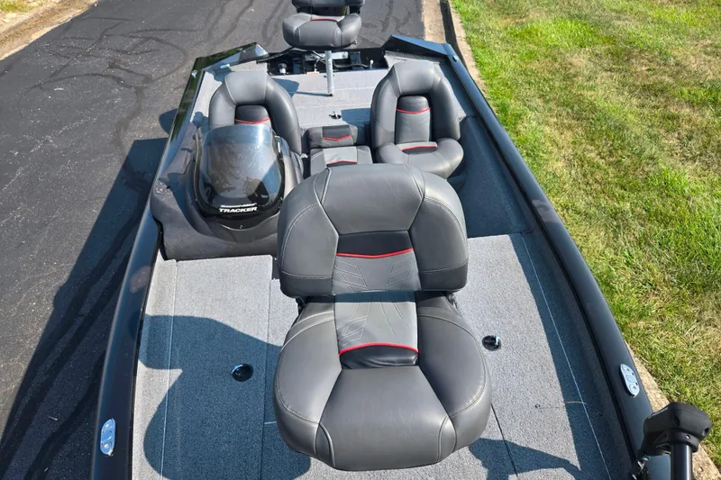 Slide: The Image of 2023 Tracker Pro Team 175 TXW boat with gray and black seating on a sunny day. - 20