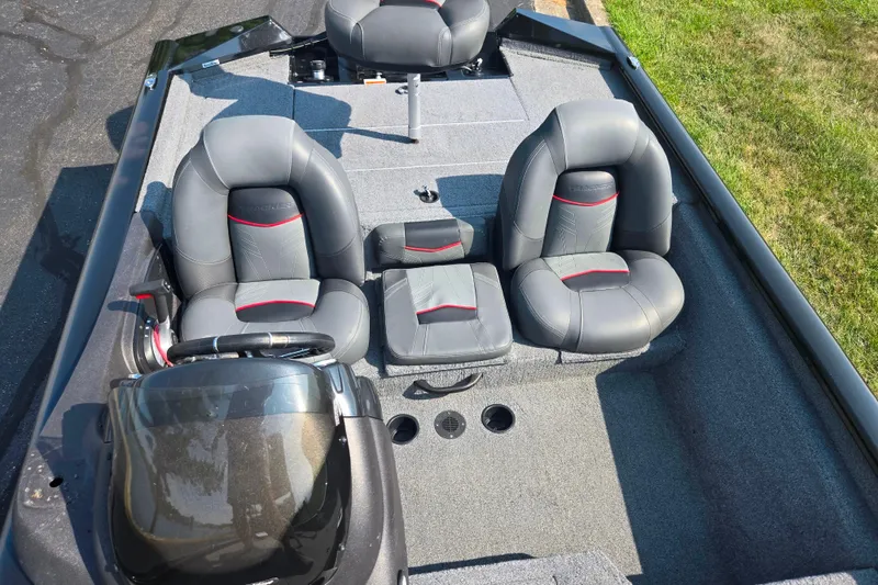 Slide: The Image of 2023 Tracker Pro Team 175 TXW boat interior with gray seating and steering console. - 21