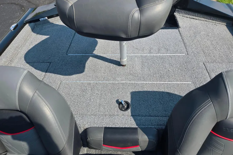Slide: The Image of 2023 Tracker Pro Team 175 TXW boat interior with gray carpet and seating. - 23