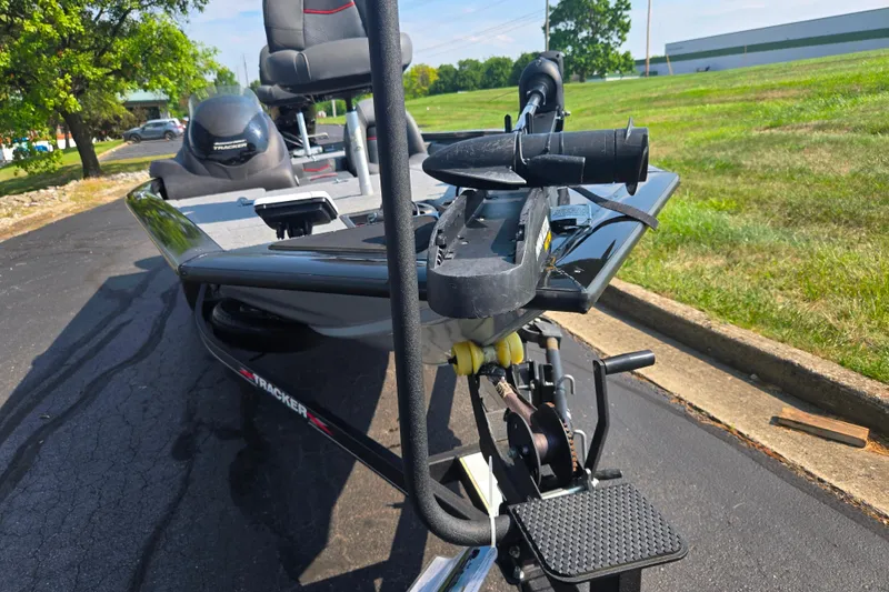 Slide: The Image of 2023 Tracker Pro Team 175 TXW boat on trailer, parked on asphalt, sunny day. - 6