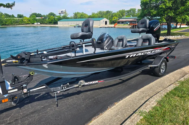 Slide: The Image of 2023 Tracker Pro Team 175 TXW fishing boat on trailer by a lake. - 9