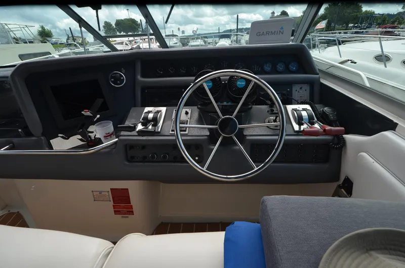 Slide: The Image of Cockpit of 1990 Sea Ray 350 Sundancer Coupe with steering wheel and control panel. - 10