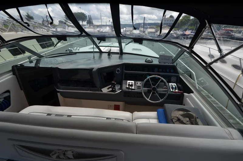 Slide: The Image of Cockpit of 1990 Sea Ray 350 Sundancer Coupe with steering wheel and navigation equipment. - 11