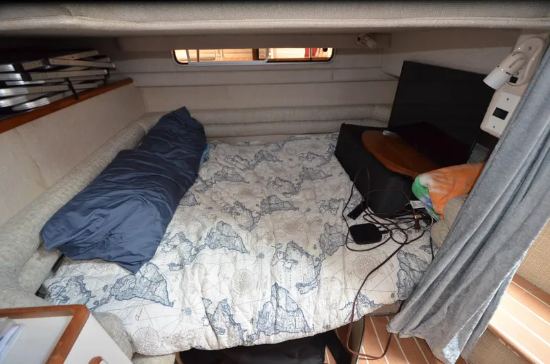 Slide: The Image of Cozy cabin interior of 1990 Sea Ray 350 Sundancer Coupe with bed and nautical decor. - 14