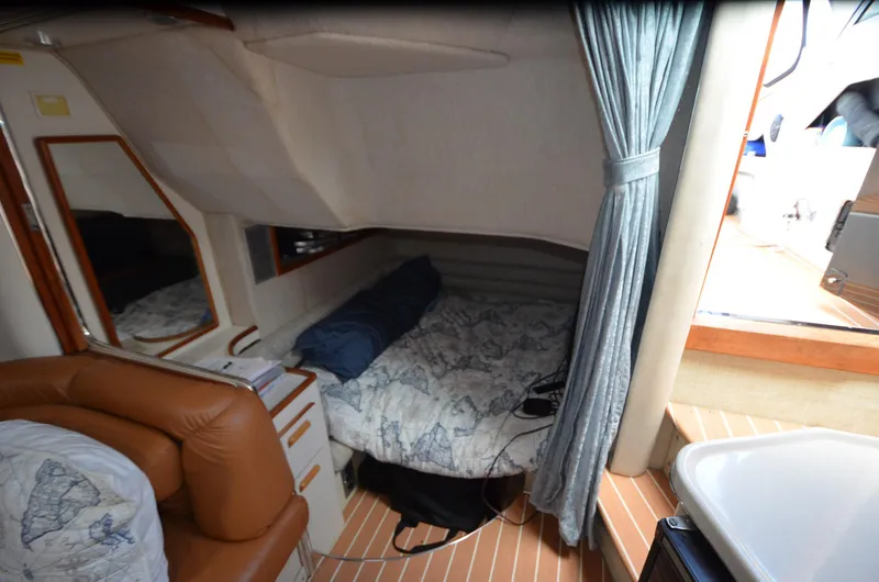 Slide: The Image of Interior cabin of 1990 Sea Ray 350 Sundancer Coupe with bed and seating area. - 15