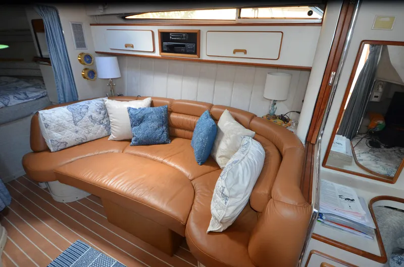 Slide: The Image of Interior of 1990 Sea Ray 350 Sundancer Coupe with leather seating and decorative pillows. - 16