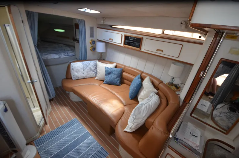 Slide: The Image of Interior of 1990 Sea Ray 350 Sundancer Coupe with leather seating and cozy cabin. - 17