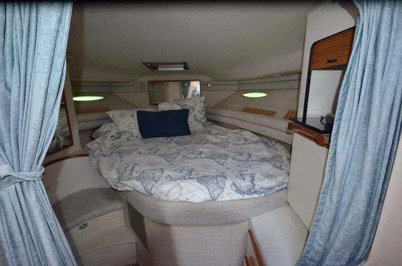Slide: The Image of Cozy cabin interior of 1990 Sea Ray 350 Sundancer Coupe with nautical bedding. - 18
